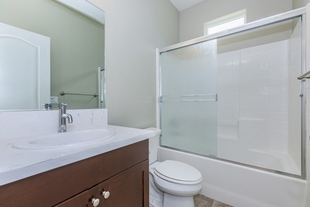 a bathroom with a sink toilet and shower