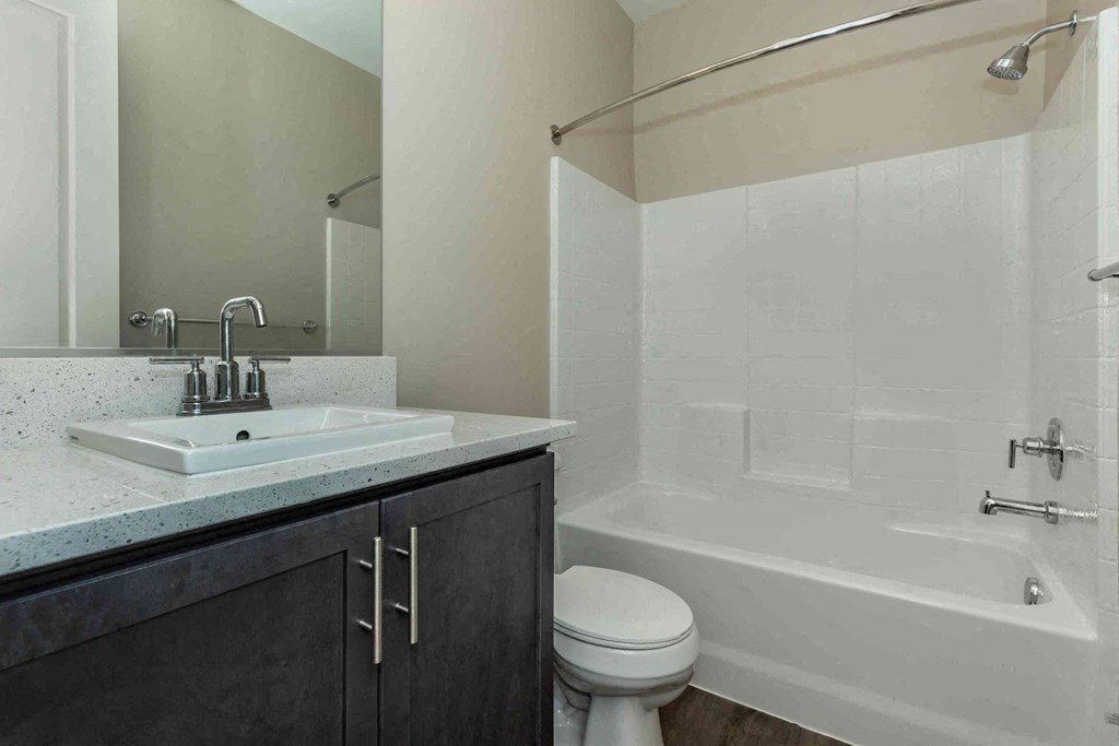 a bathroom with a sink toilet and a tub