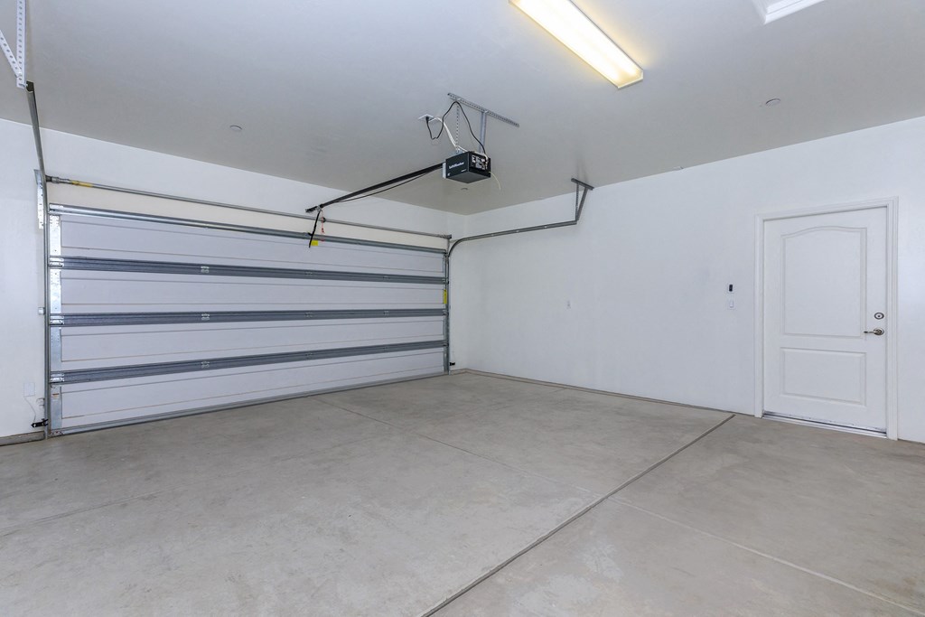 the interior of a garage with a white wall and a door