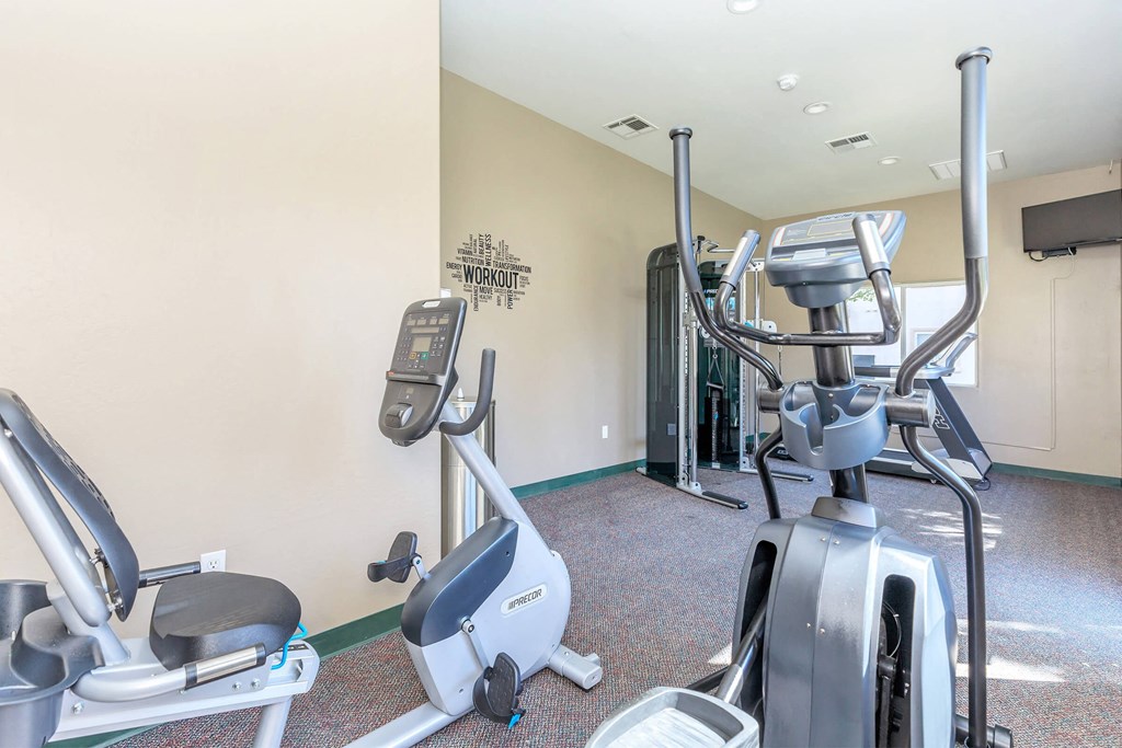 the gym at the preserve at polo towers is equipped with exercise bikes and weights