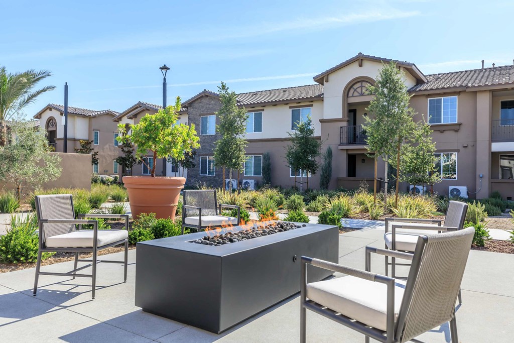 an outdoor patio with chairs and a fire pit