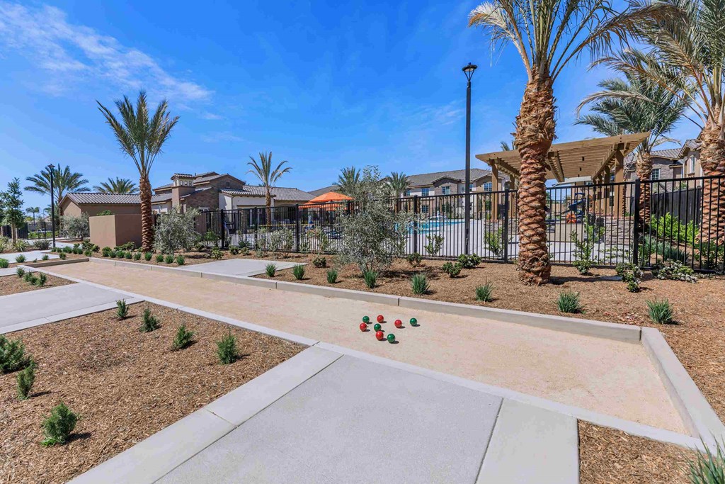a community with a walkway and palm trees