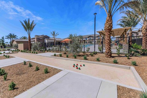 a community with a walkway and palm trees