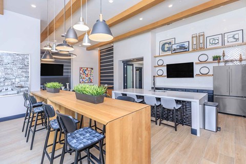 a kitchen with a long wooden table and chairs
