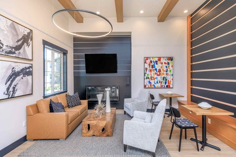 a living room with couches and chairs and a fireplace