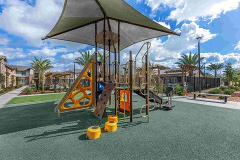 a playground with a swing set and other playground equipment in a community