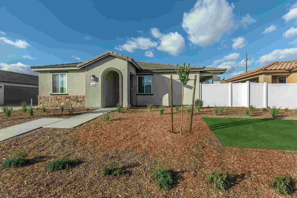 a house with a yard and lawn in front of it