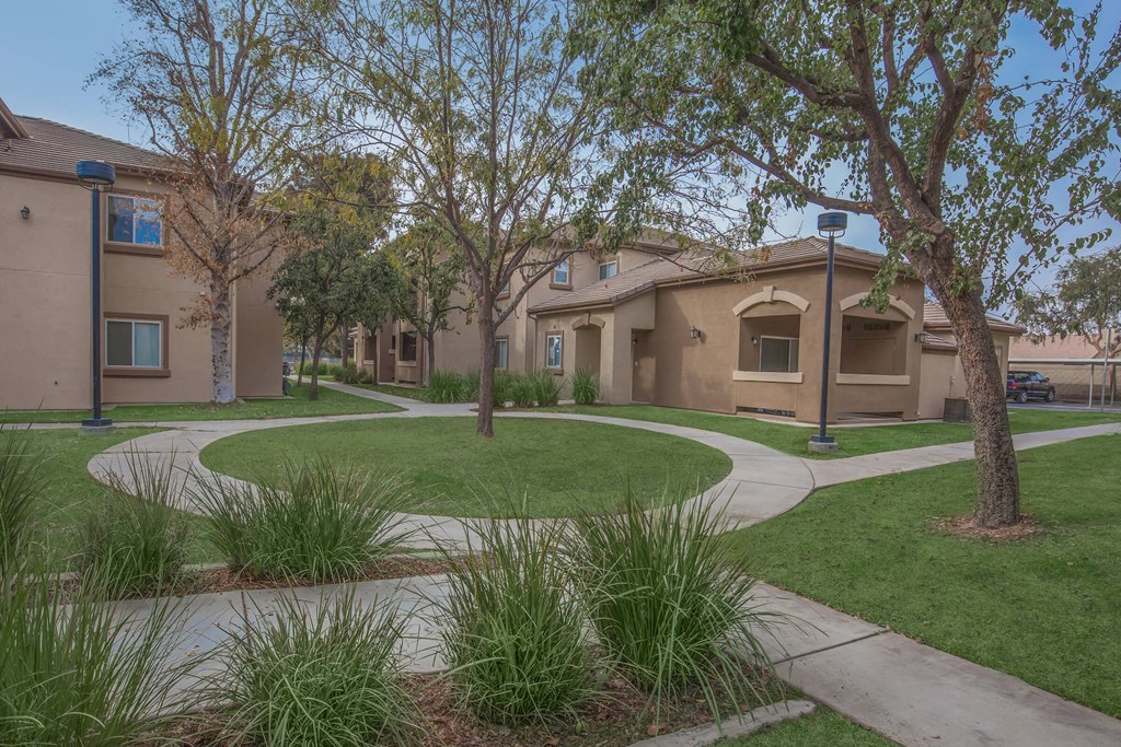 a city street with houses and trees and sidewalks