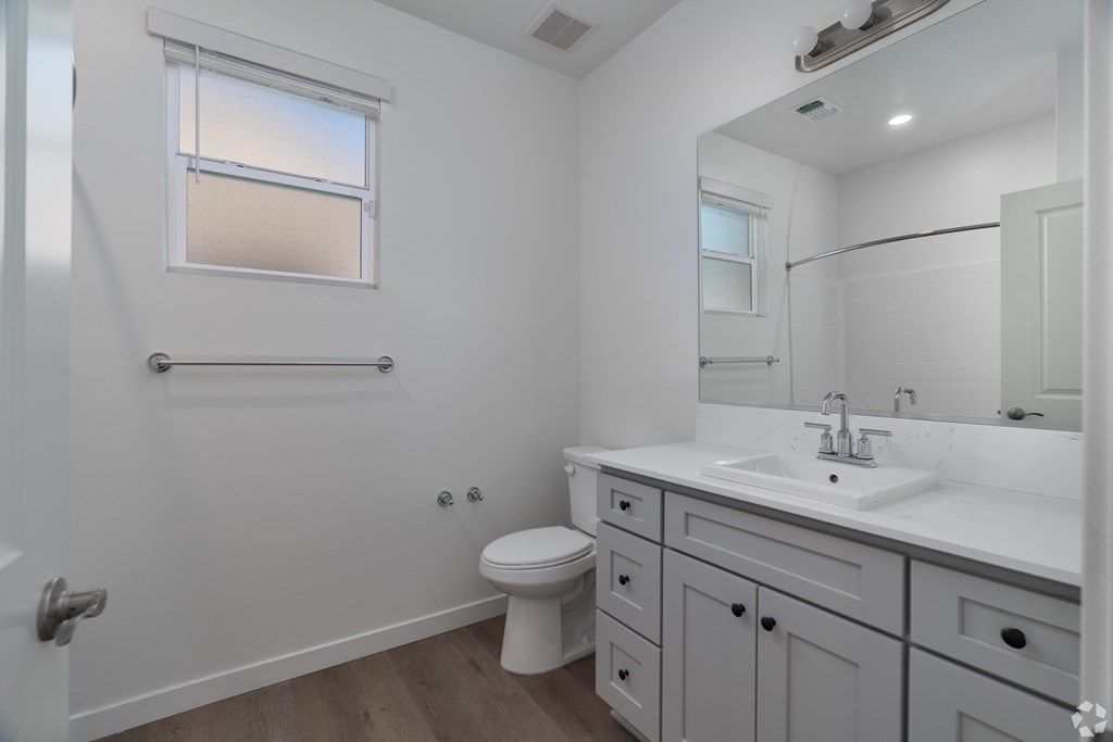 an empty bathroom with a sink and a toilet