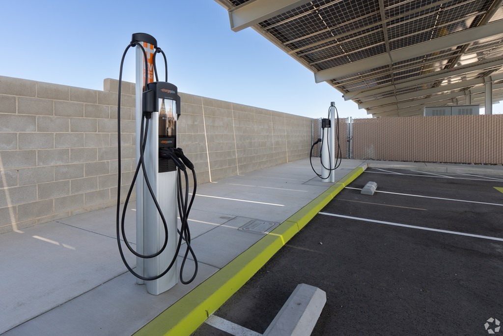 A parking lot with a charging station for electric vehicles.