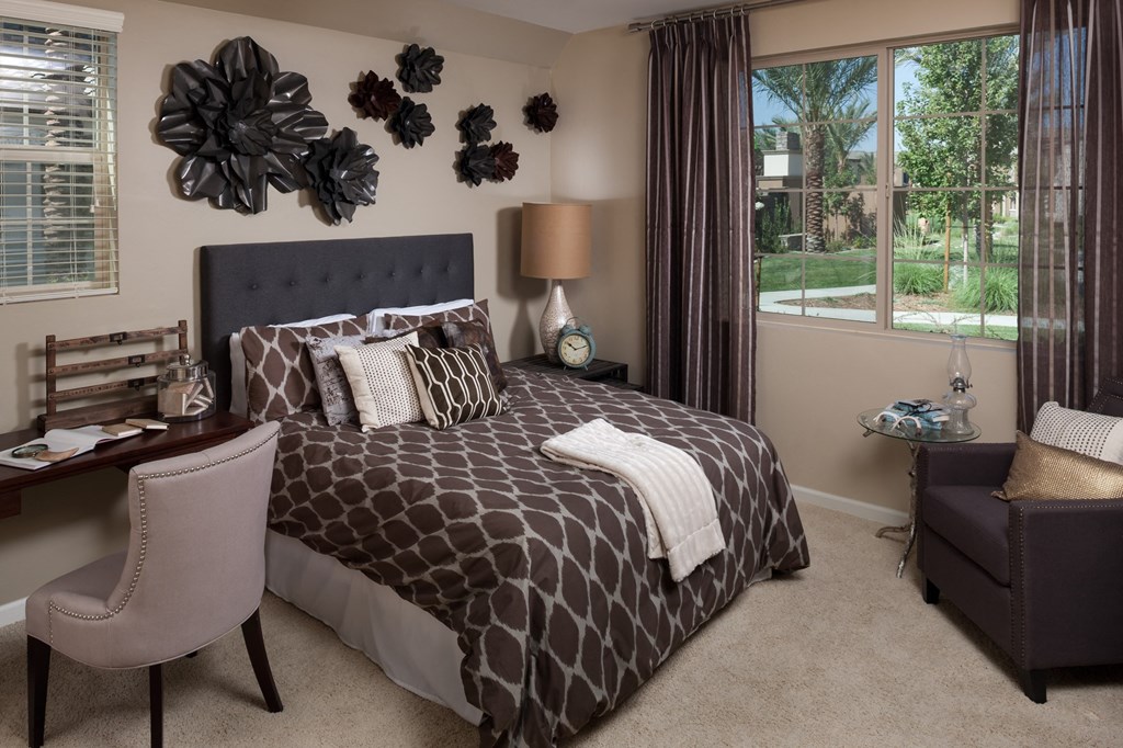 a bedroom with a bed and flowers on the wall