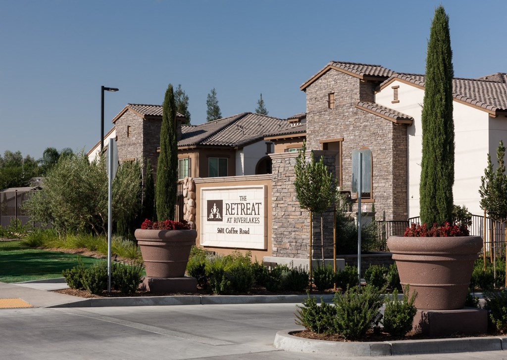 the exterior of a building with a sign in front of it