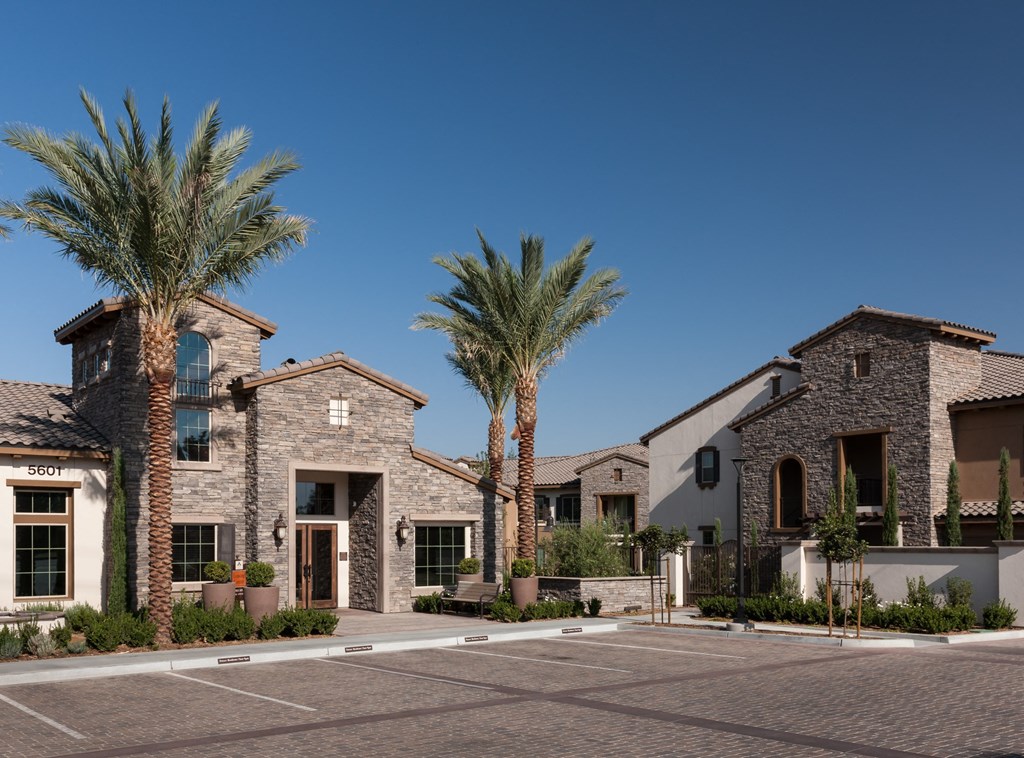 a large building with palm trees in front of it