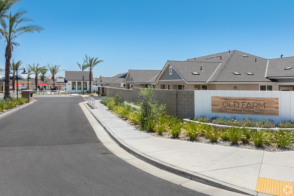 A street view of a residential area with the name "OLD FARM" on a building.