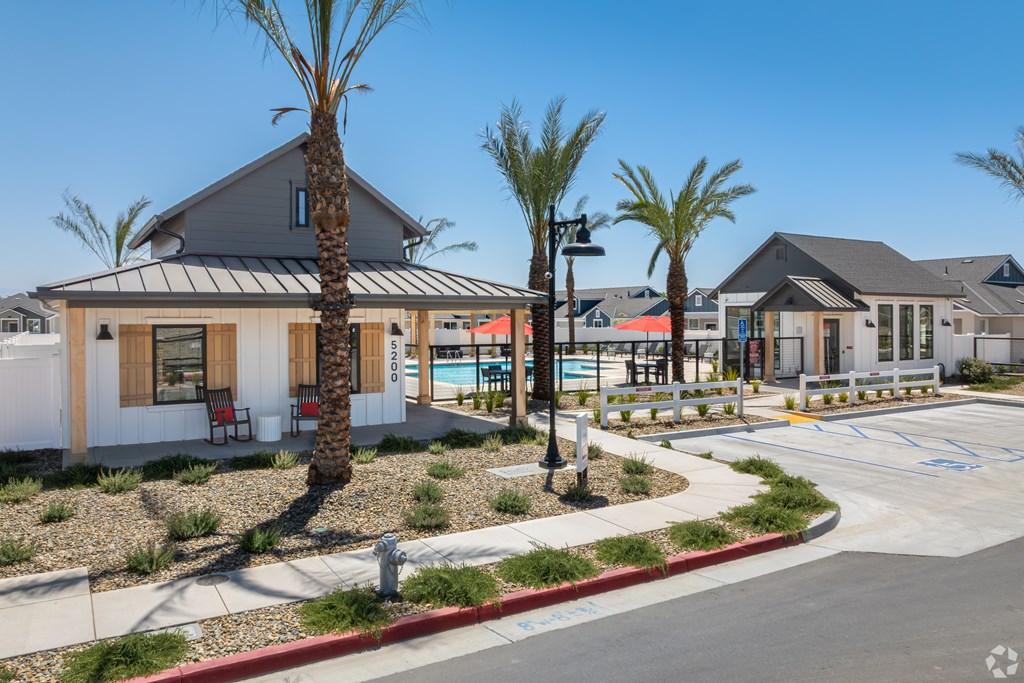 A sunny day at a residential area with houses and palm trees.