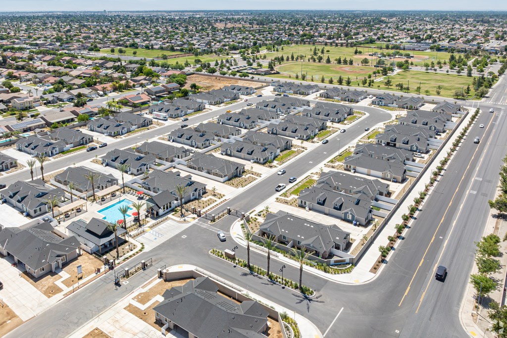 A bird's eye view of a residential area with houses and roads.