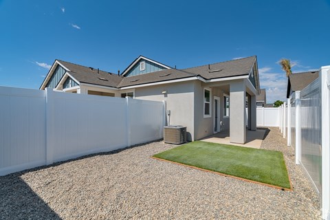a house with a white fence and a grass yard