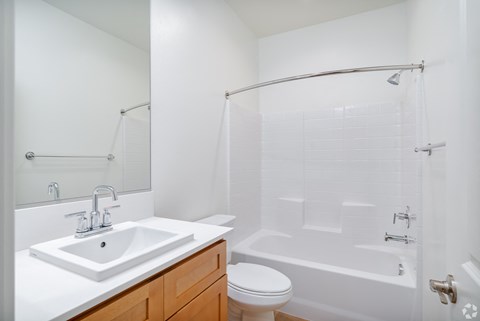 a small bathroom with a sink toilet and shower