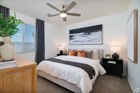 a bedroom with a large bed and a ceiling fan