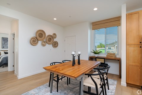 a dining room with a wooden table and chairs