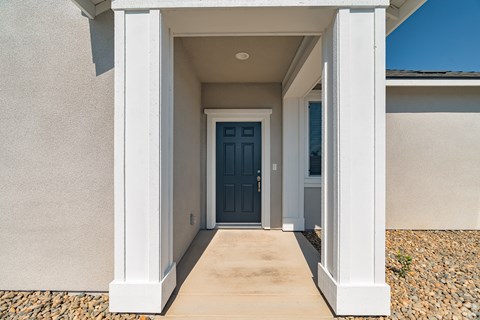 a welcoming entrance to a home with a blue door
