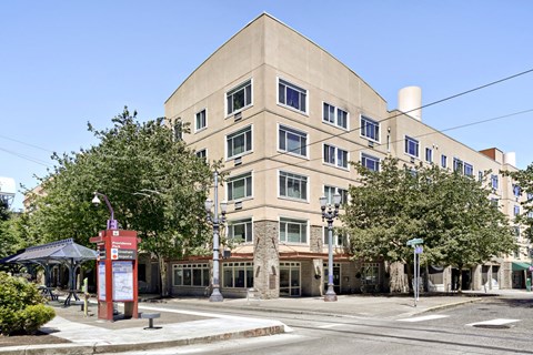 A large building with a red sign in front of it.