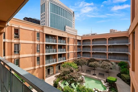 A courtyard with a pool surrounded by buildings.