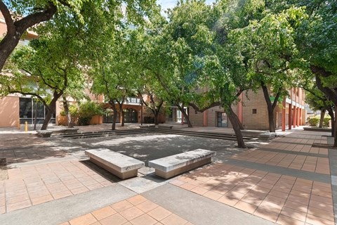 A courtyard with a fountain surrounded by trees and buildings at Pin Yuen