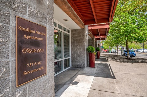 Property entrance sign with red awning at Stadium Station Apartments, Portland, OR 97205