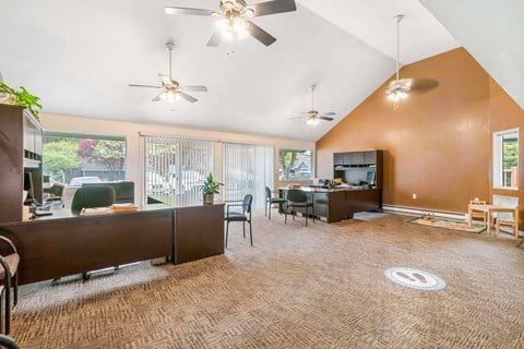 A living room with a brown carpet and a brown couch.