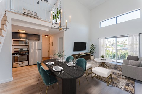 a living room and dining room with a table and chairs