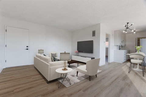 a living room with a white couch and a tv