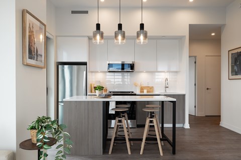 A modern kitchen with a dining table and chairs.