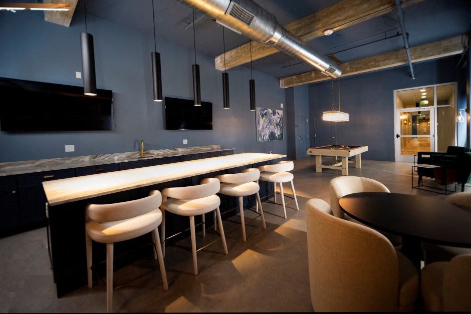 a bar with chairs and tables in a room with blue walls