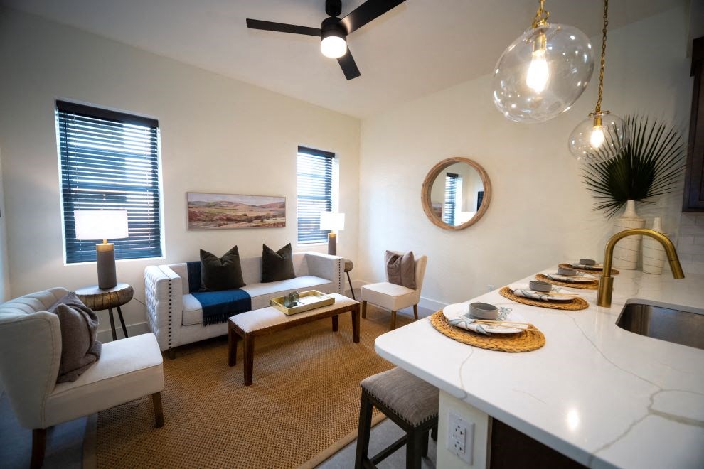 a living room with a kitchen and a dining table