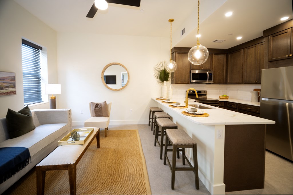 a kitchen and living room with a large island and a dining table