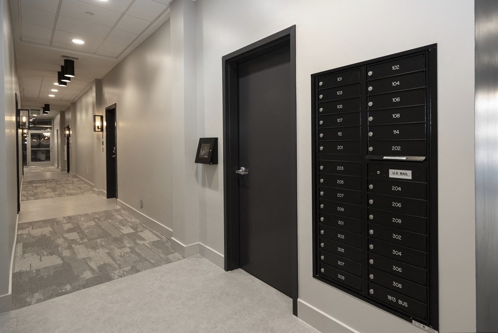 a view of the elevators in the hallway of a building with a locker room