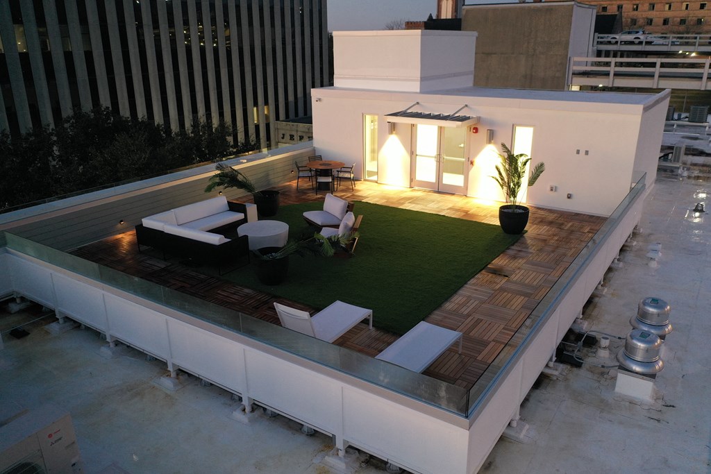 a roof terrace with a lawn on top of a building