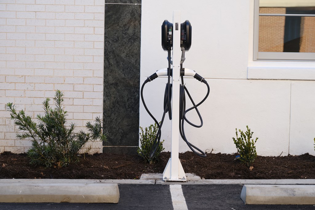a pair of parking meters are plugged into the side of a building