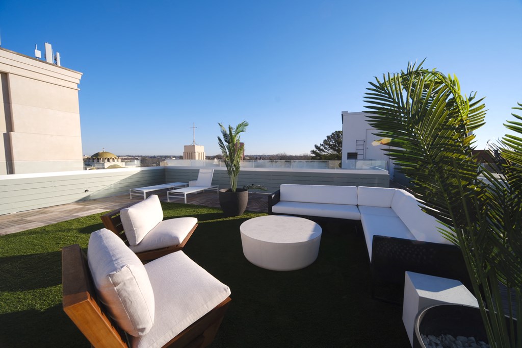 a roof top terrace with couches and a table