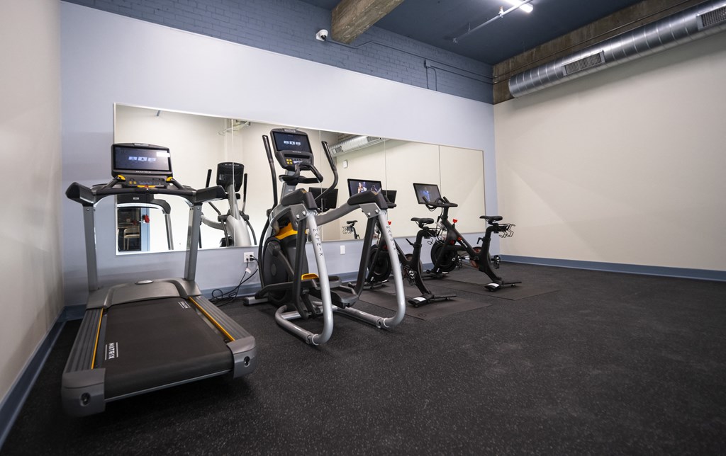 a group of exercise bikes in a gym