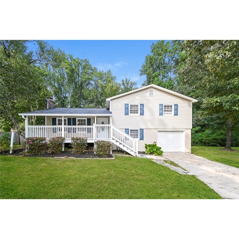 A house with a white porch and a white garage door.