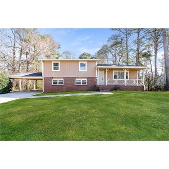a home with a lawn and a driveway