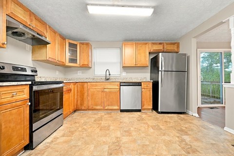 A kitchen with wooden cabinets and a black oven.