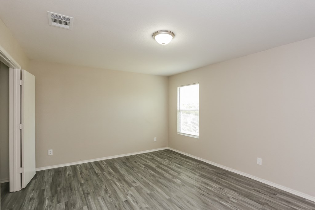 A room with a window and a door.