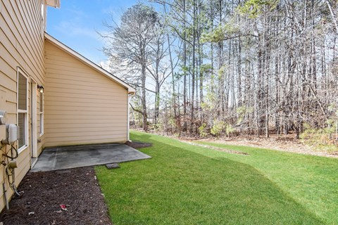 A house with a small backyard and a shed.