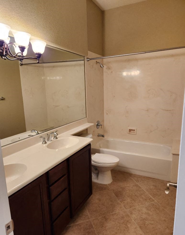 a bathroom with a toilet and a sink and a bath tub