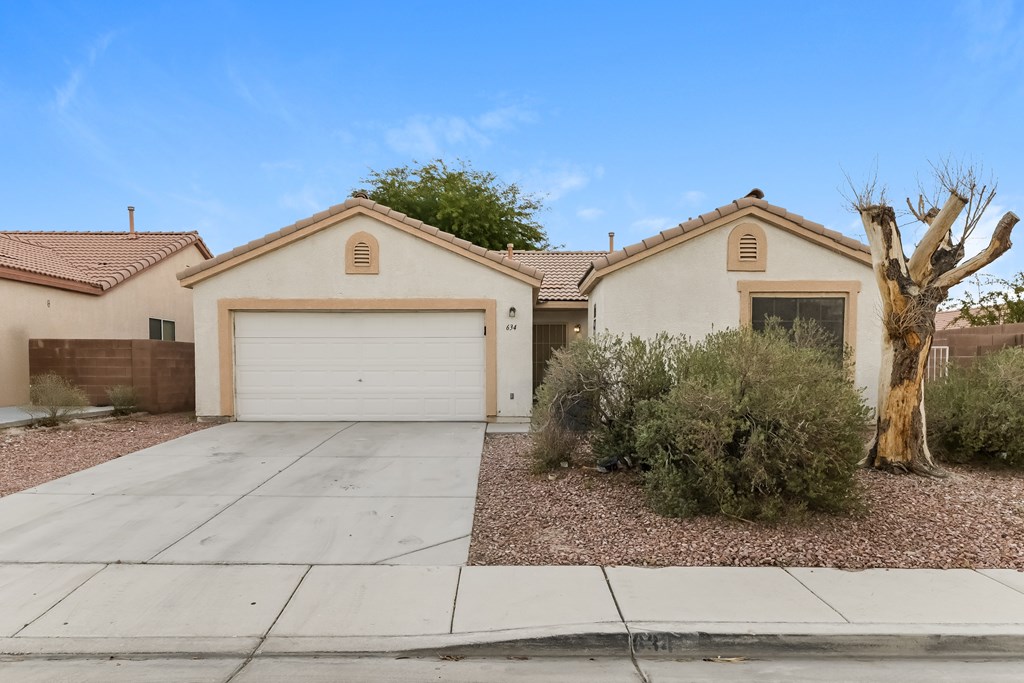A house with a garage and a driveway.
