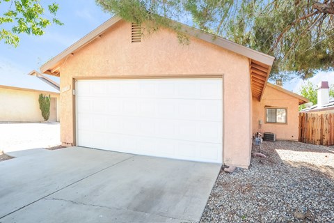 A house with a white garage door and a brown roof.