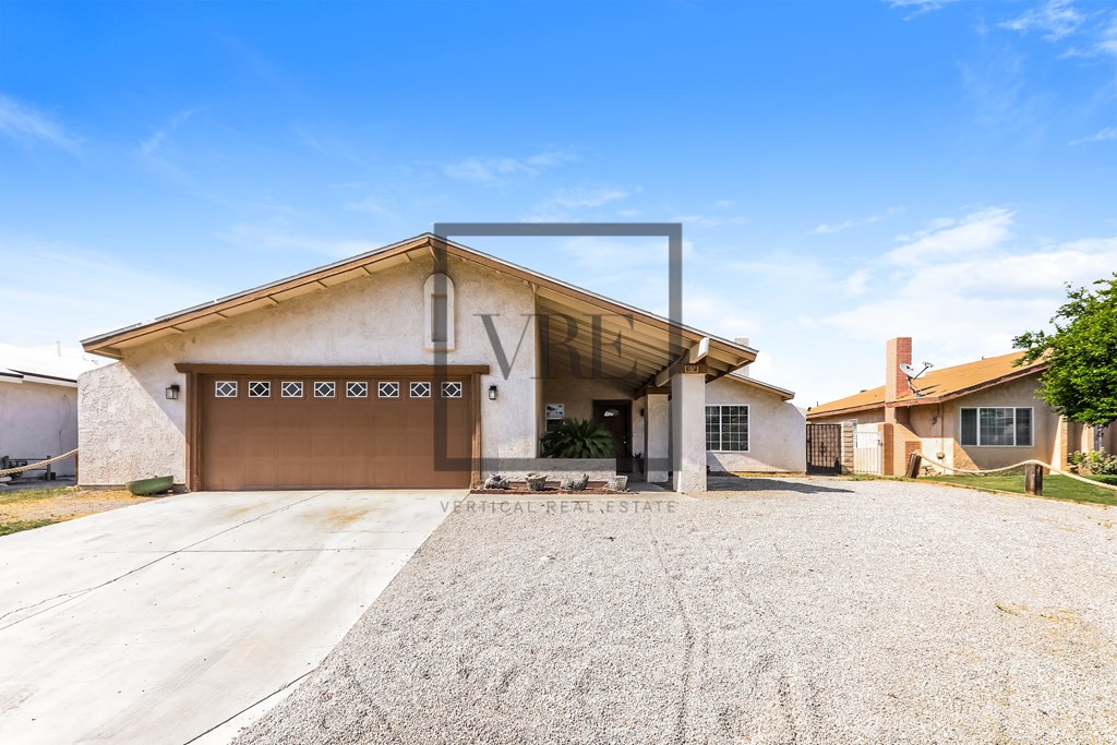 A house with a garage door that is open.